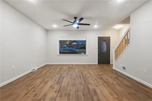 wooden floor in an empty room with a window