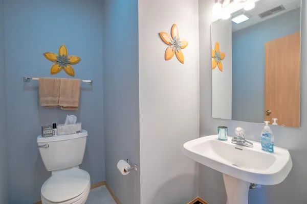 a bathroom with a sink mirror and toilet