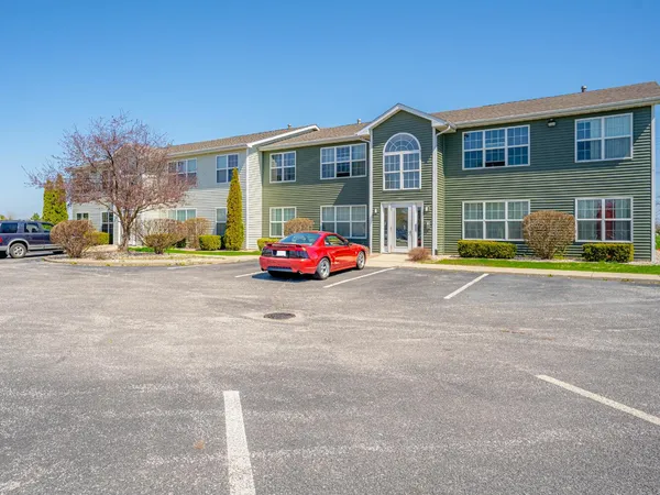 a car parked in front of a brick building