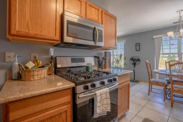 a kitchen with stainless steel appliances granite countertop a stove and a microwave