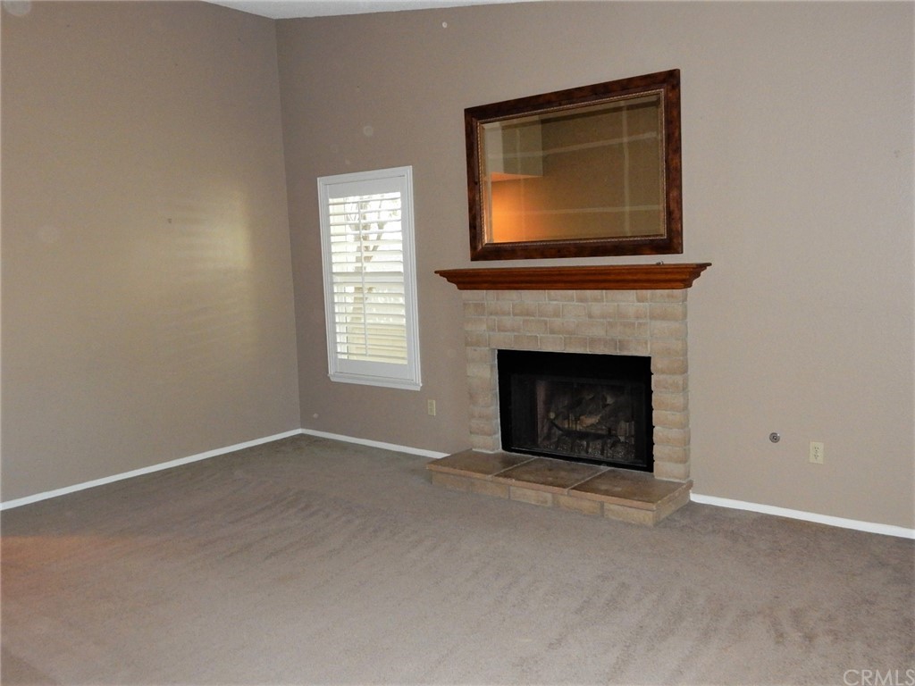 175 North Torn Ranch Road Lake Elsinore, CA 92530 - Photo 4 of 31 Front door opens to your living room with a fireplace.