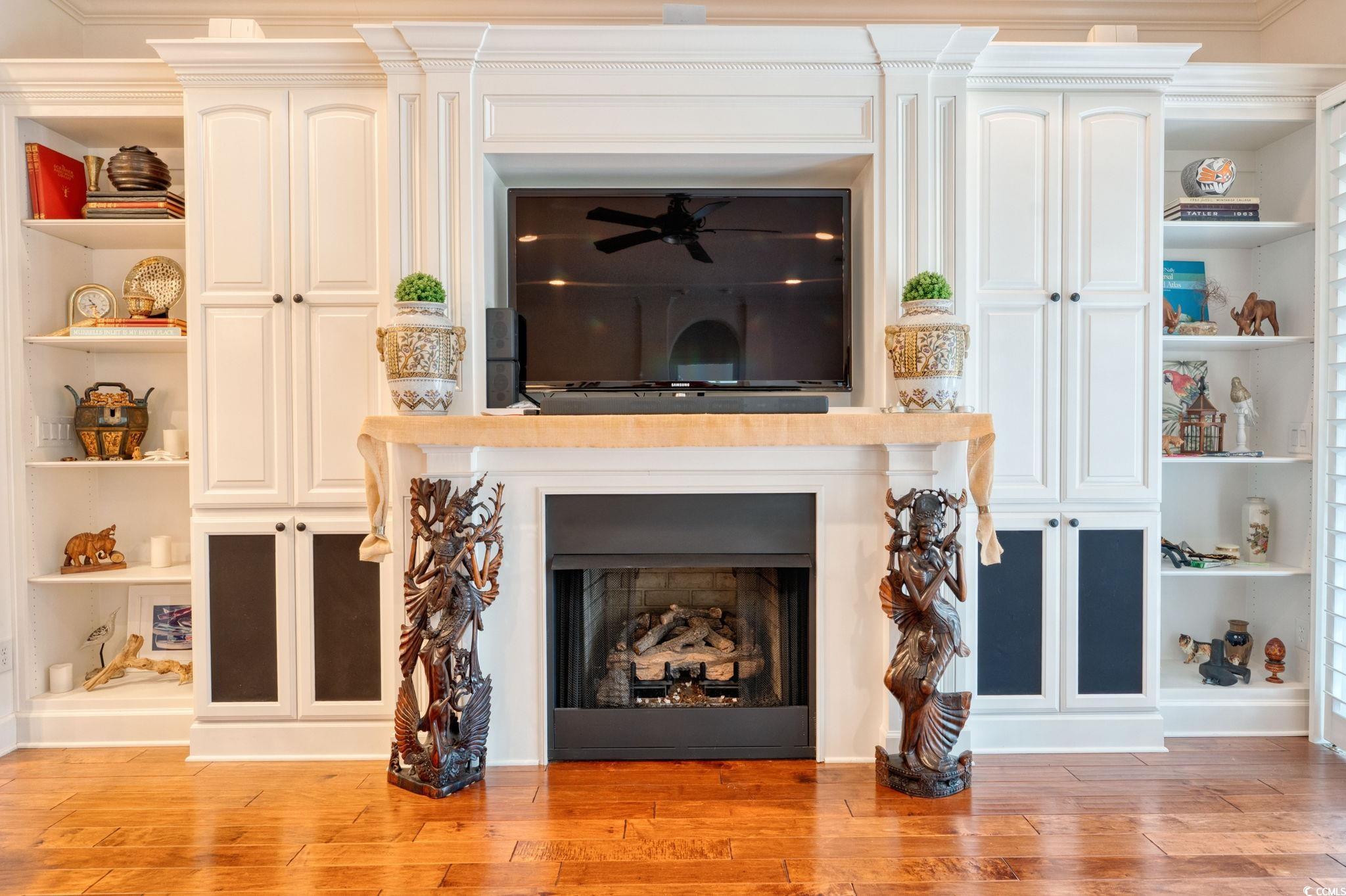 492 Grand Cypress Way Murrells Inlet, SC 29576 - Photo 15 of 40 Detailed view of wood finished floors, built in shelves, ceiling fan, ornamental molding, and a fireplace