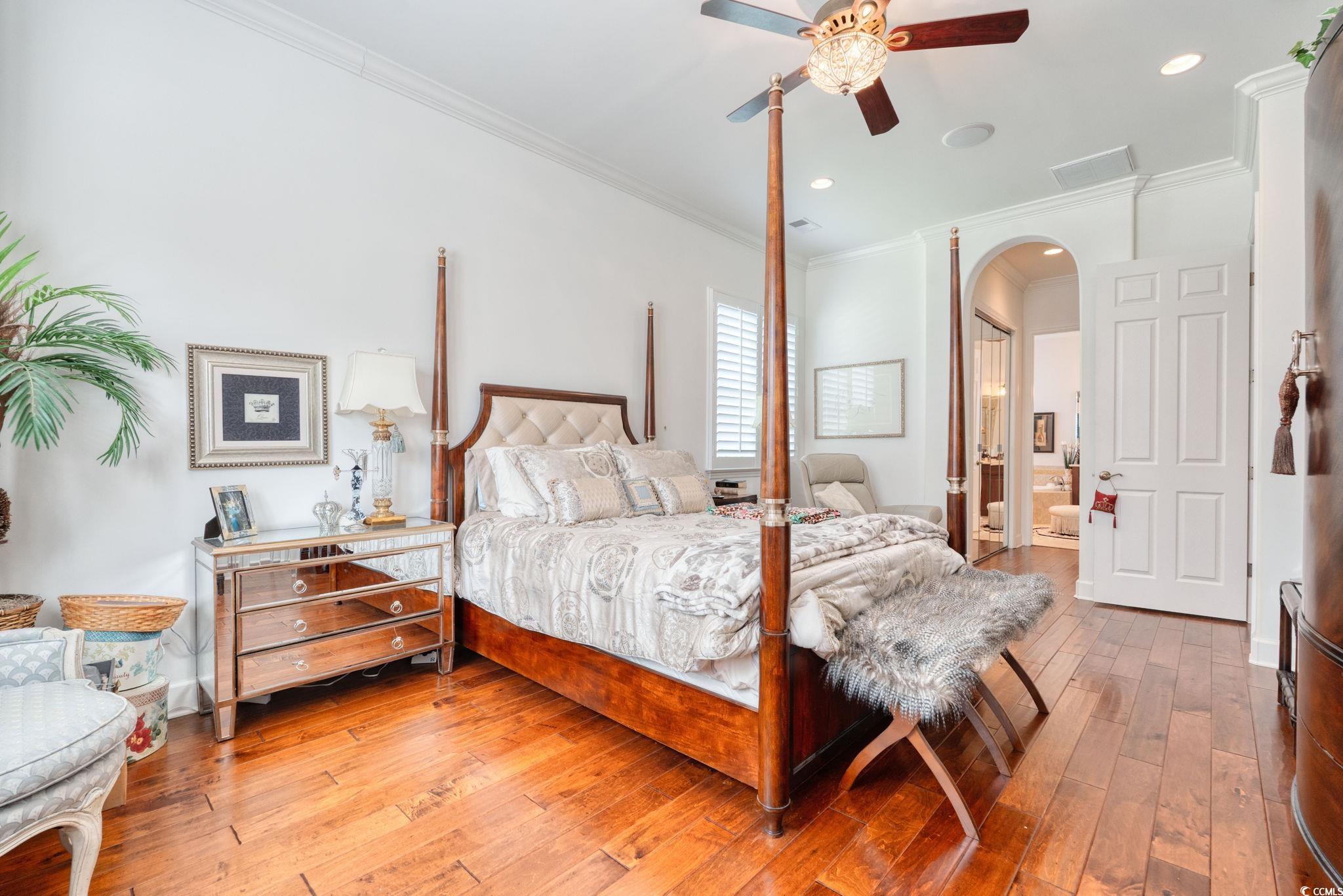 492 Grand Cypress Way Murrells Inlet, SC 29576 - Photo 19 of 40 Bedroom featuring arched walkways, hardwood / wood-style floors, crown molding, recessed lighting, and connected bathroom