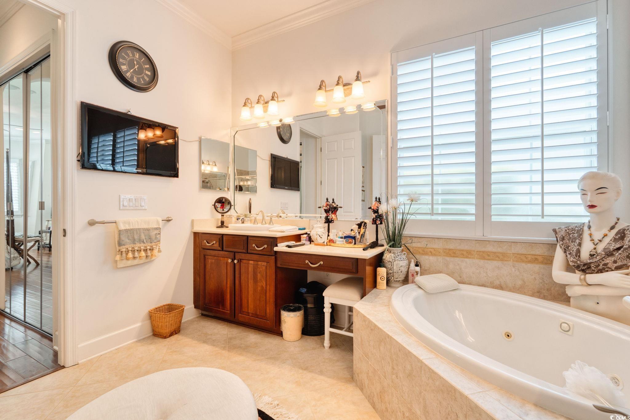 492 Grand Cypress Way Murrells Inlet, SC 29576 - Photo 23 of 40 Bathroom featuring a whirlpool tub, vanity, crown molding, and tile patterned floors