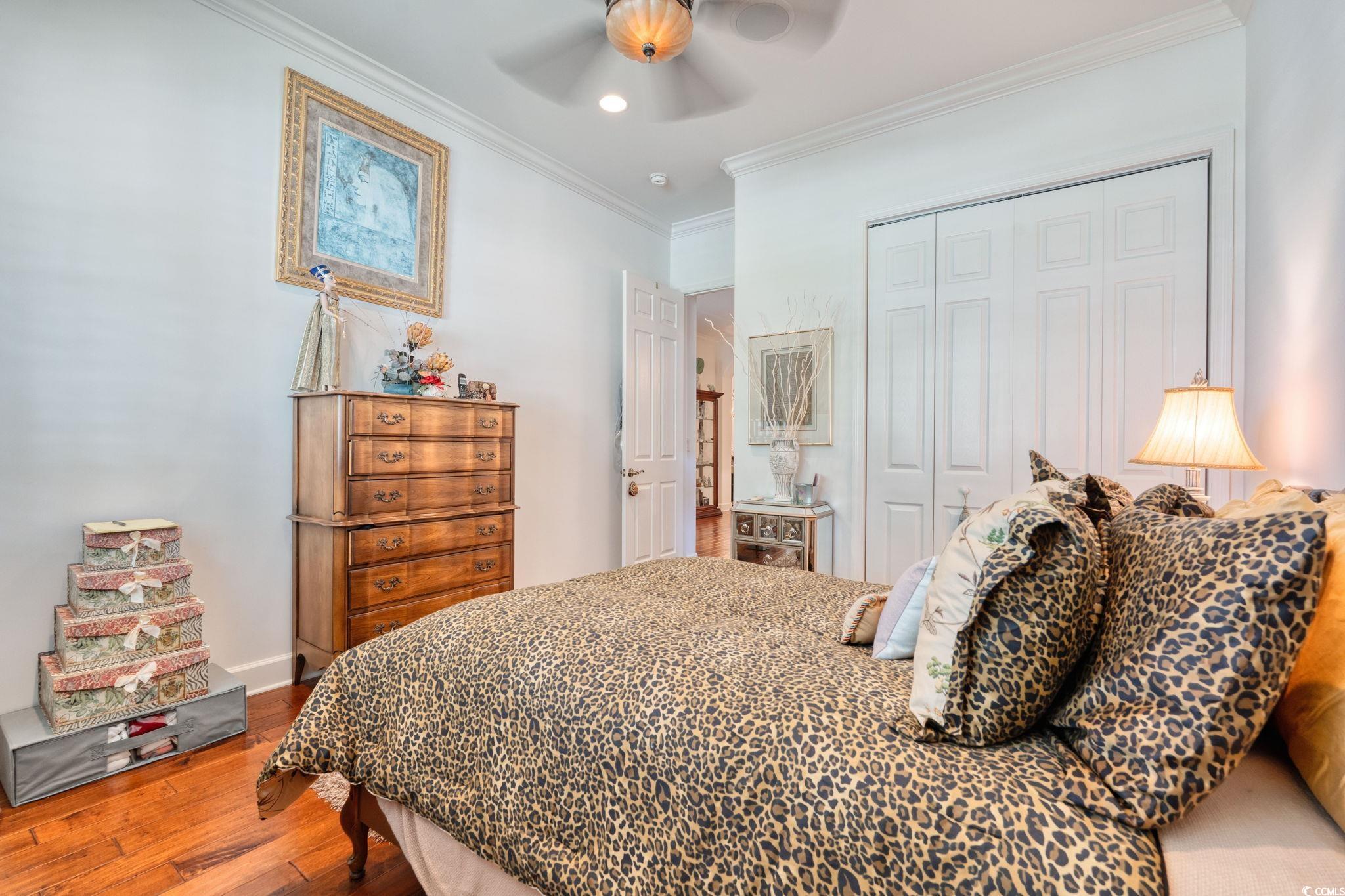 492 Grand Cypress Way Murrells Inlet, SC 29576 - Photo 24 of 40 Bedroom with a closet, wood finished floors, crown molding, a ceiling fan, and recessed lighting