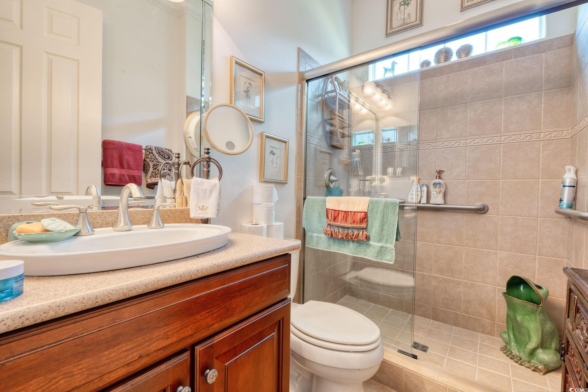 492 Grand Cypress Way Murrells Inlet, SC 29576 - Photo 27 of 40 Bathroom featuring vanity and tiled shower