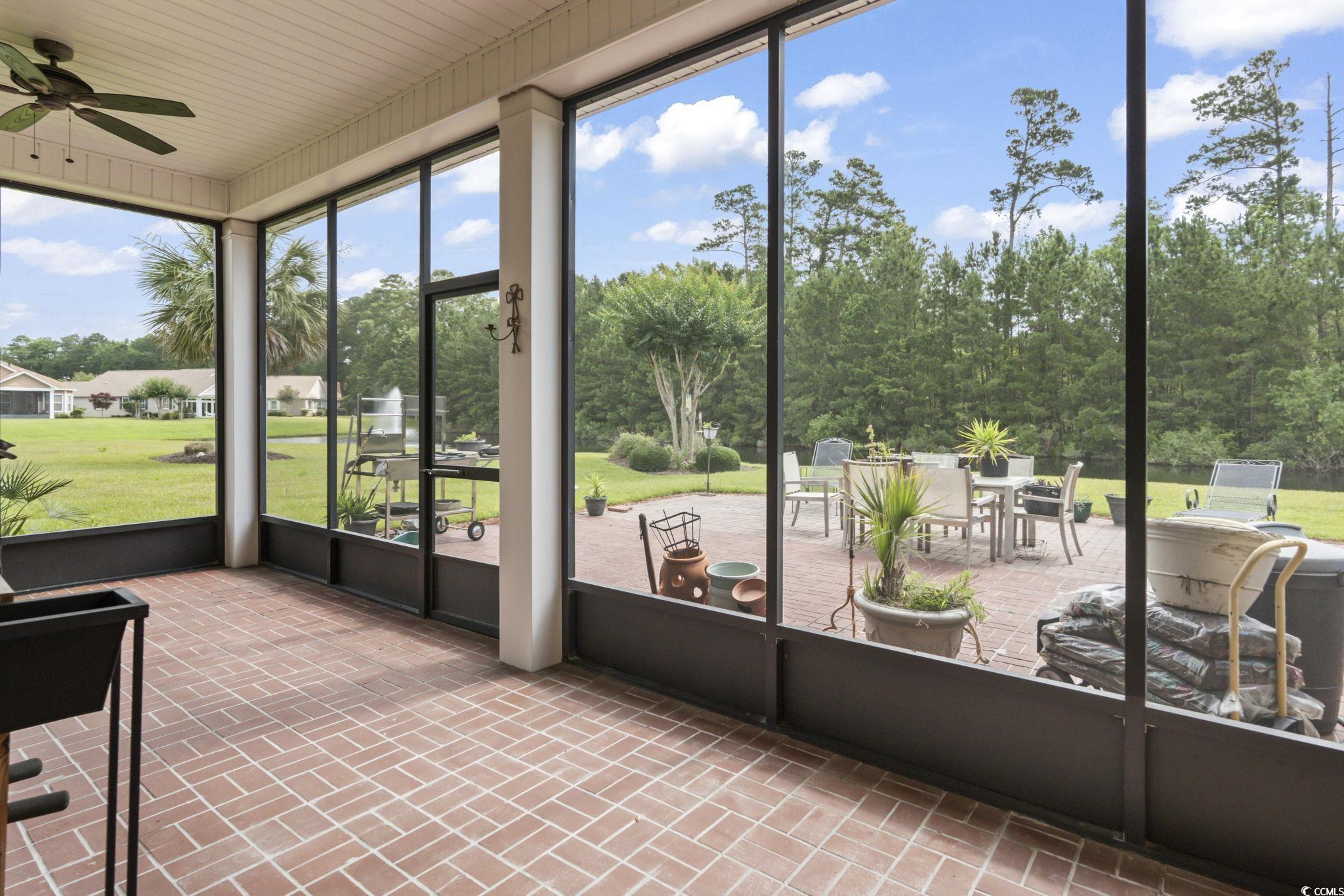 492 Grand Cypress Way Murrells Inlet, SC 29576 - Photo 28 of 40 Sunroom / solarium featuring a ceiling fan, outdoor dining area, and view of scattered trees