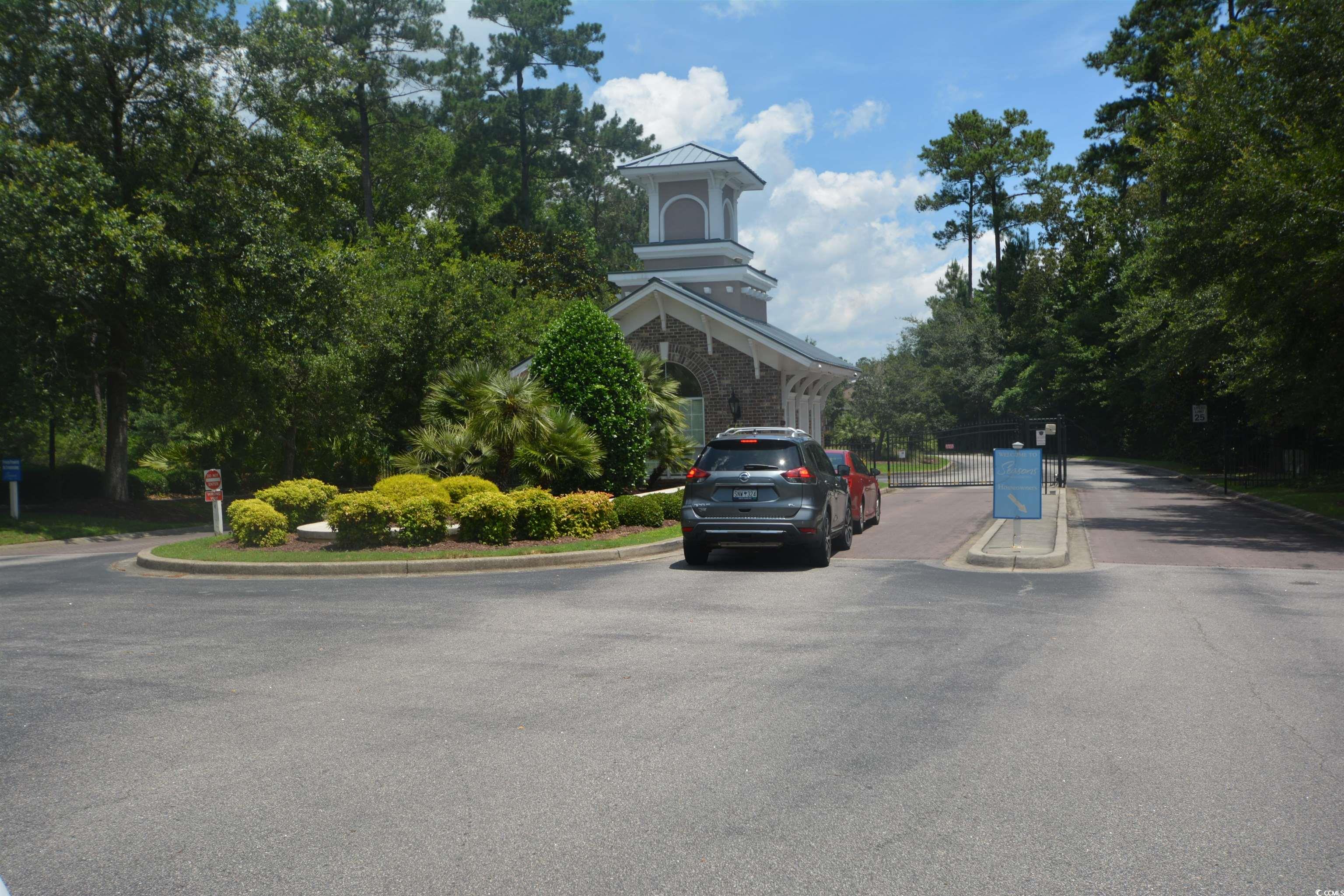 492 Grand Cypress Way Murrells Inlet, SC 29576 - Photo 29 of 40 View of asphalt road featuring curbs and view of scattered trees