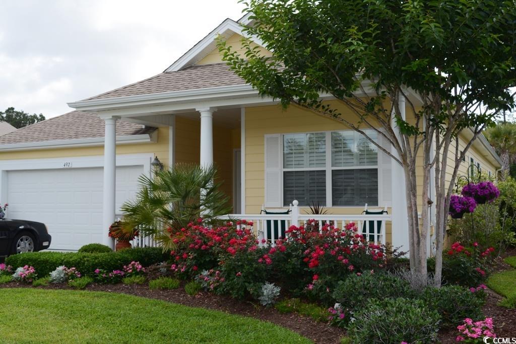 492 Grand Cypress Way Murrells Inlet, SC 29576 - Photo 7 of 40 View of front of property featuring an attached garage, a shingled roof, and covered porch
