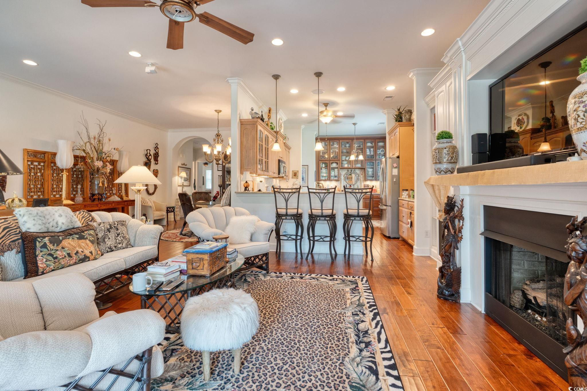 492 Grand Cypress Way Murrells Inlet, SC 29576 - Photo 9 of 40 Living room with a ceiling fan, light wood finished floors, ornamental molding, a fireplace, and recessed lighting