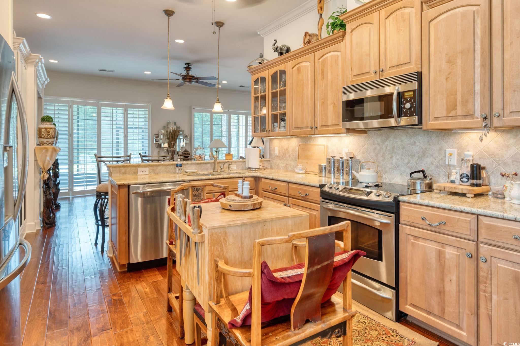 492 Grand Cypress Way Murrells Inlet, SC 29576 - Photo 10 of 40 Kitchen with appliances with stainless steel finishes, light brown cabinets, a peninsula, a ceiling fan, and recessed lighting