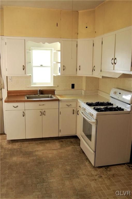 915 Spring Street Bethlehem, PA 18018 - Photo 5 of 20 a kitchen with granite countertop white cabinets and white appliances