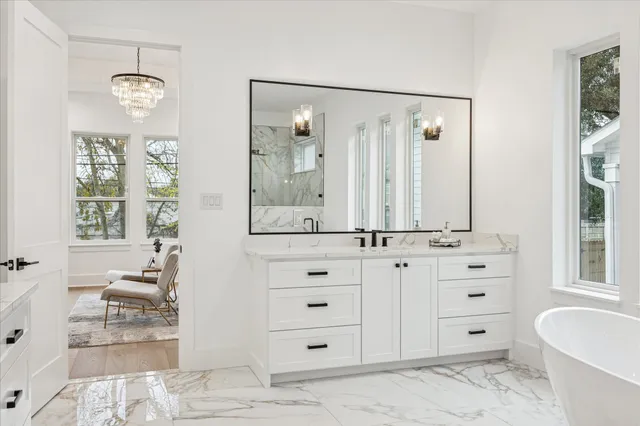 a bathroom with a double vanity sink a mirror and a bathtub