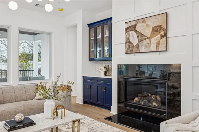 a living room with furniture a table and a fireplace