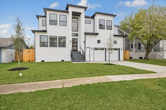 a view of a house with a big yard and large trees