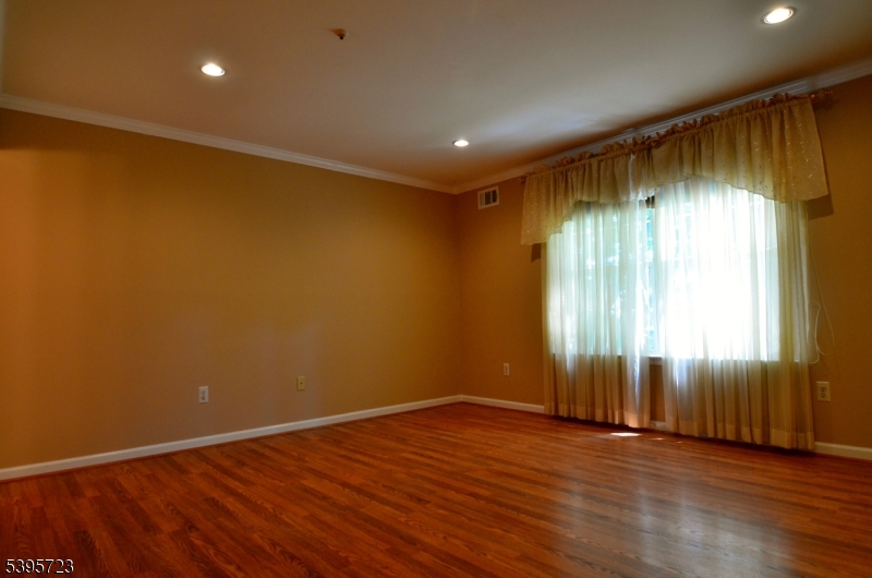 45 Crestview Lane Mount Arlington, NJ 07856 - Photo 6 of 11 an empty room with wooden floor and windows