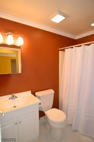 a bathroom with a sink a toilet and shower curtain