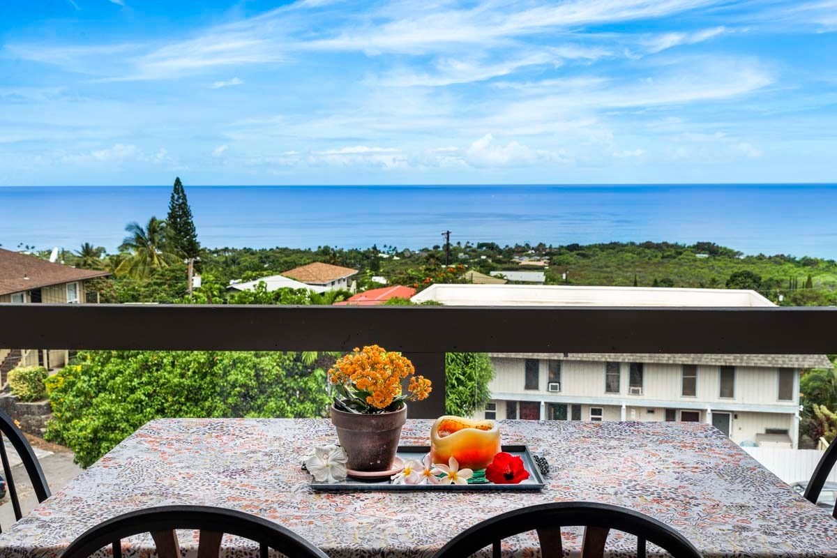 77-301 Noelani Way, Unit 31 Kailua-Kona, HI 96740 - Photo 1 of 26 a view of a balcony with dining table and chairs