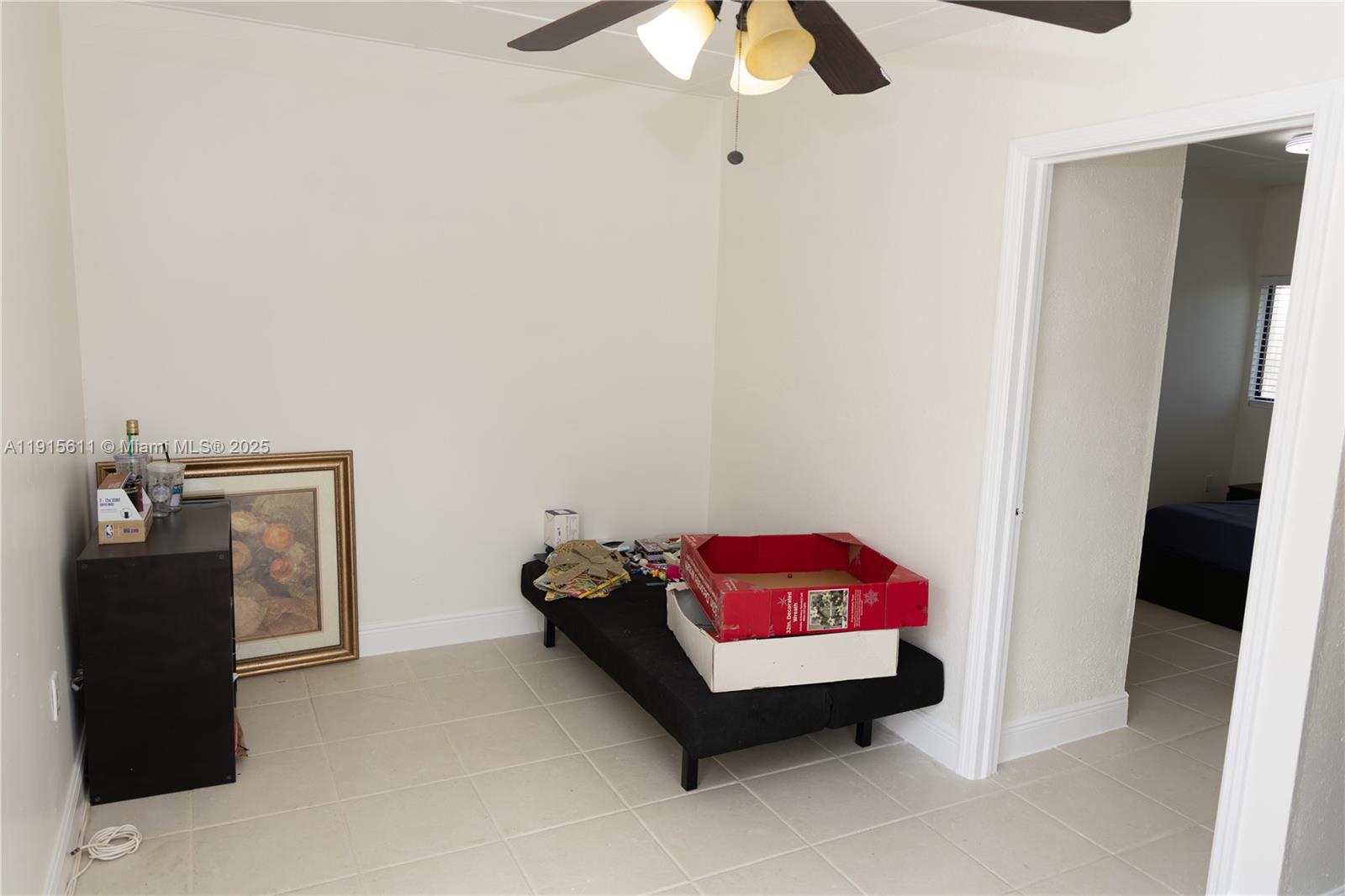 14280 Southwest 285th Street, Unit B Homestead, FL 33033 - Photo 2 of 9 a bedroom with a bed and a chandelier