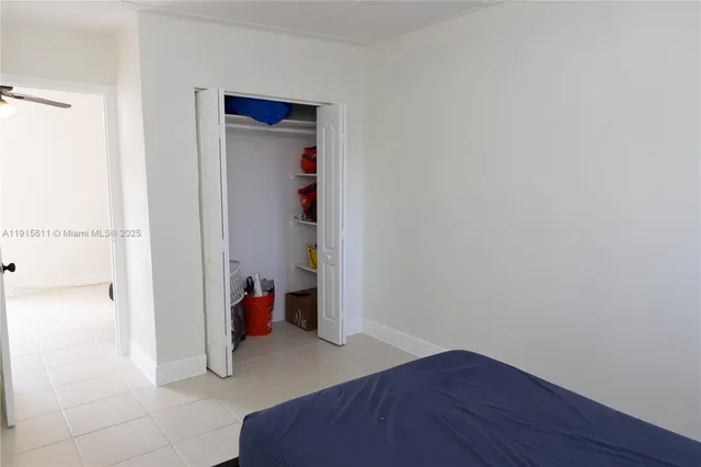 a hallway with a wooden floor and closet