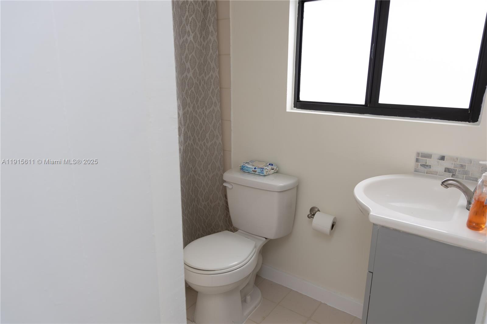 14280 Southwest 285th Street, Unit B Homestead, FL 33033 - Photo 5 of 9 a bathroom with a toilet sink and mirror