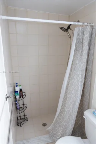 a bathroom with a shower and toilet