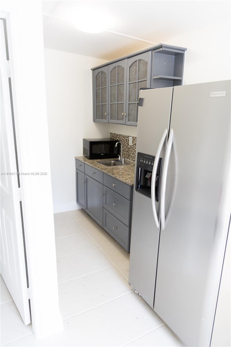 14280 Southwest 285th Street, Unit B Homestead, FL 33033 - Photo 7 of 9 a kitchen with stainless steel appliances a refrigerator and a stove