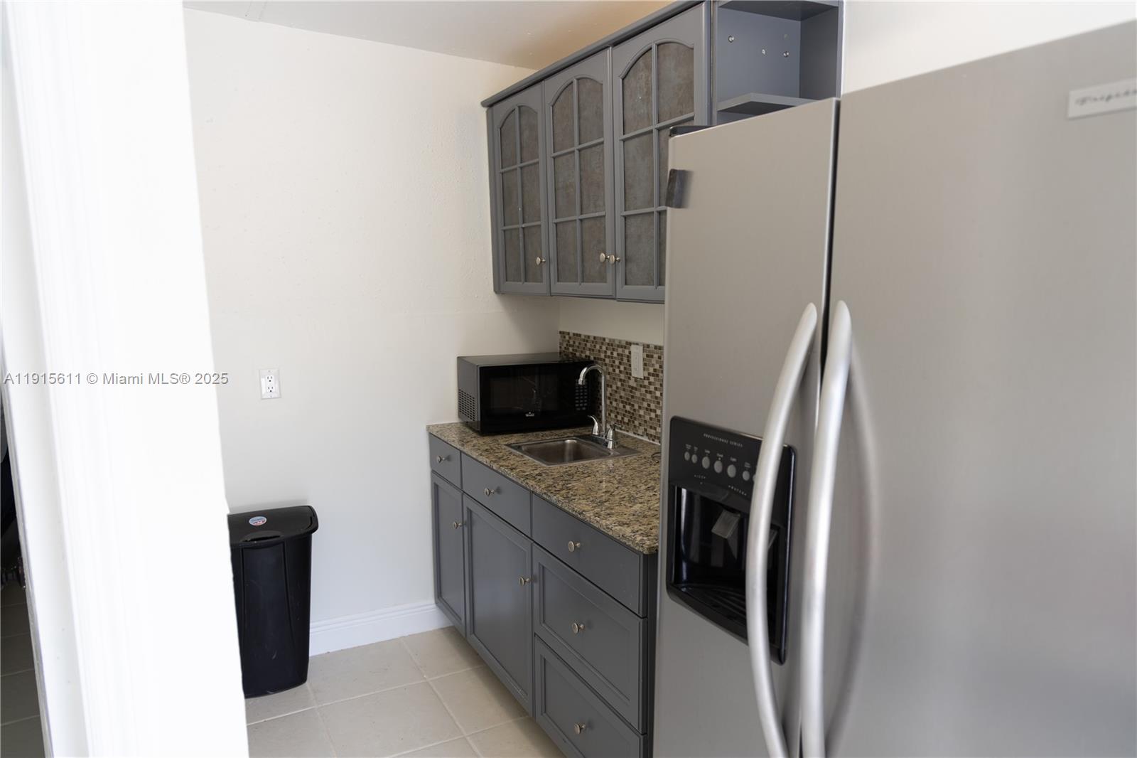 14280 Southwest 285th Street, Unit B Homestead, FL 33033 - Photo 8 of 9 a kitchen with a refrigerator and a stove top oven