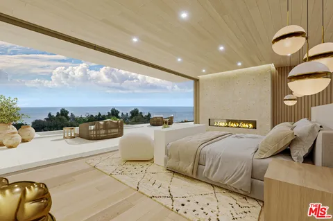 a bedroom with a large bed and a chandelier