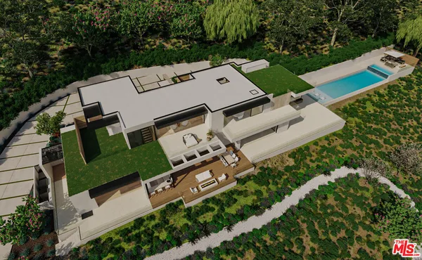 an aerial view of a house with a yard and trees