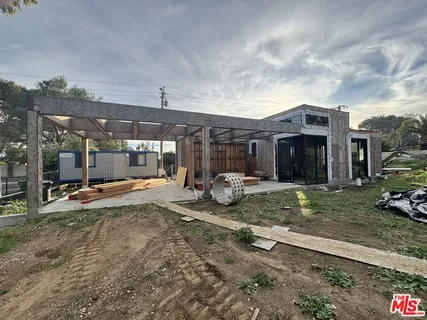 a view of a house with backyard porch and sitting area