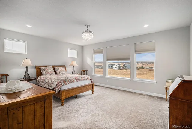 a spacious bedroom with a bed and a window