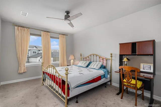 a bedroom with a bed a window and chair