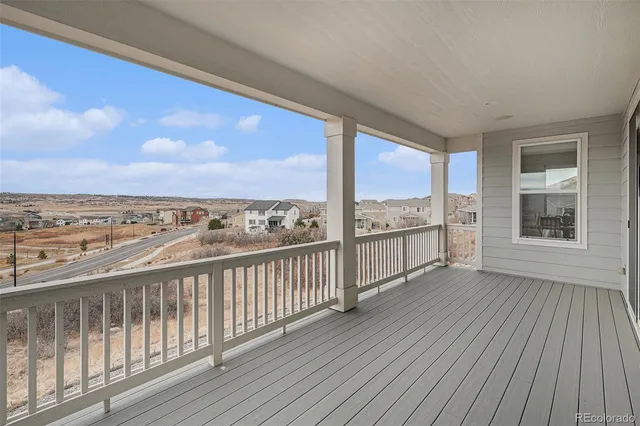 a view of a balcony with wooden floor