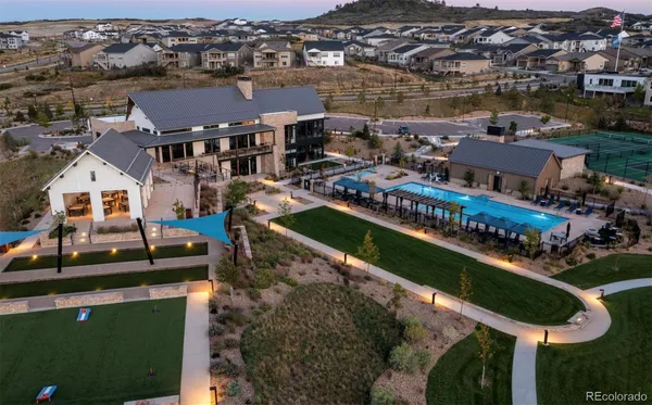an aerial view of a house with a garden and lake view