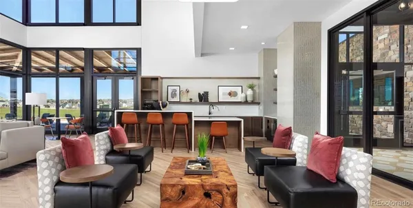 a living room with furniture and a floor to ceiling window