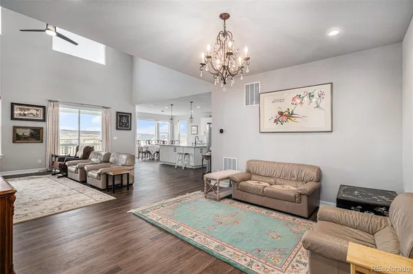 a living room with furniture or couch and a chandelier