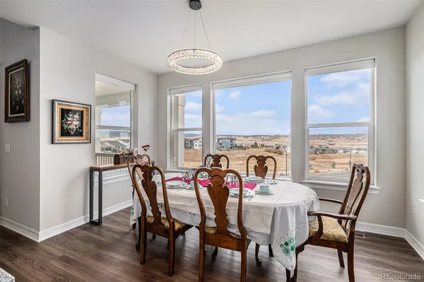 a view of a dining room with furniture window and wooden floor