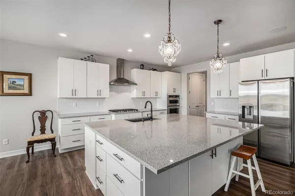 a kitchen with a center island appliances and cabinets