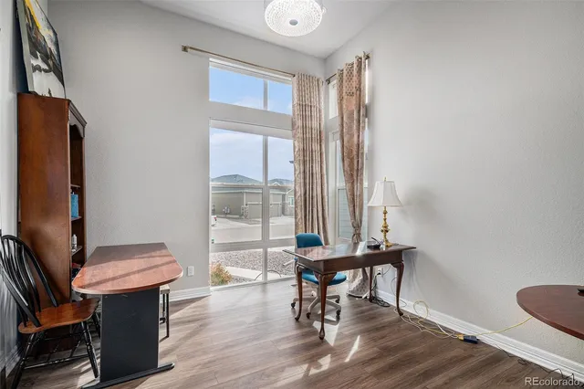 a view of a workspace with furniture and a window