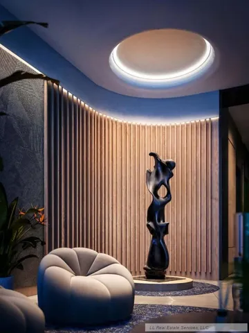 a living room with furniture and a potted plant