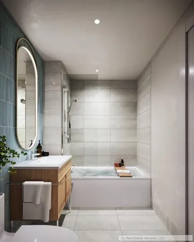 a bathroom with a bathtub and a sink