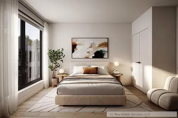 a bedroom with a large bed and a potted plant