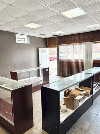 a living room with kitchen island a sink a stove and a window