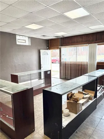 a living room with kitchen island a sink a stove and a window