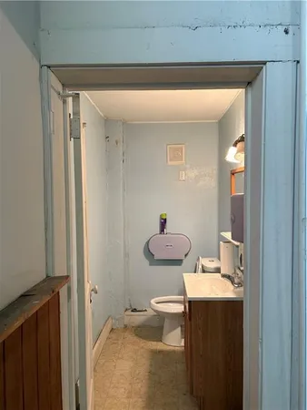 a bathroom with a granite countertop sink toilet and a mirror
