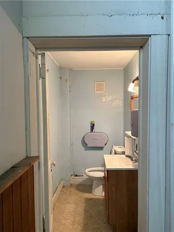 a bathroom with a granite countertop sink toilet and a mirror