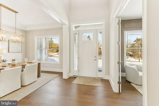a living room with furniture a couch and a potted plant