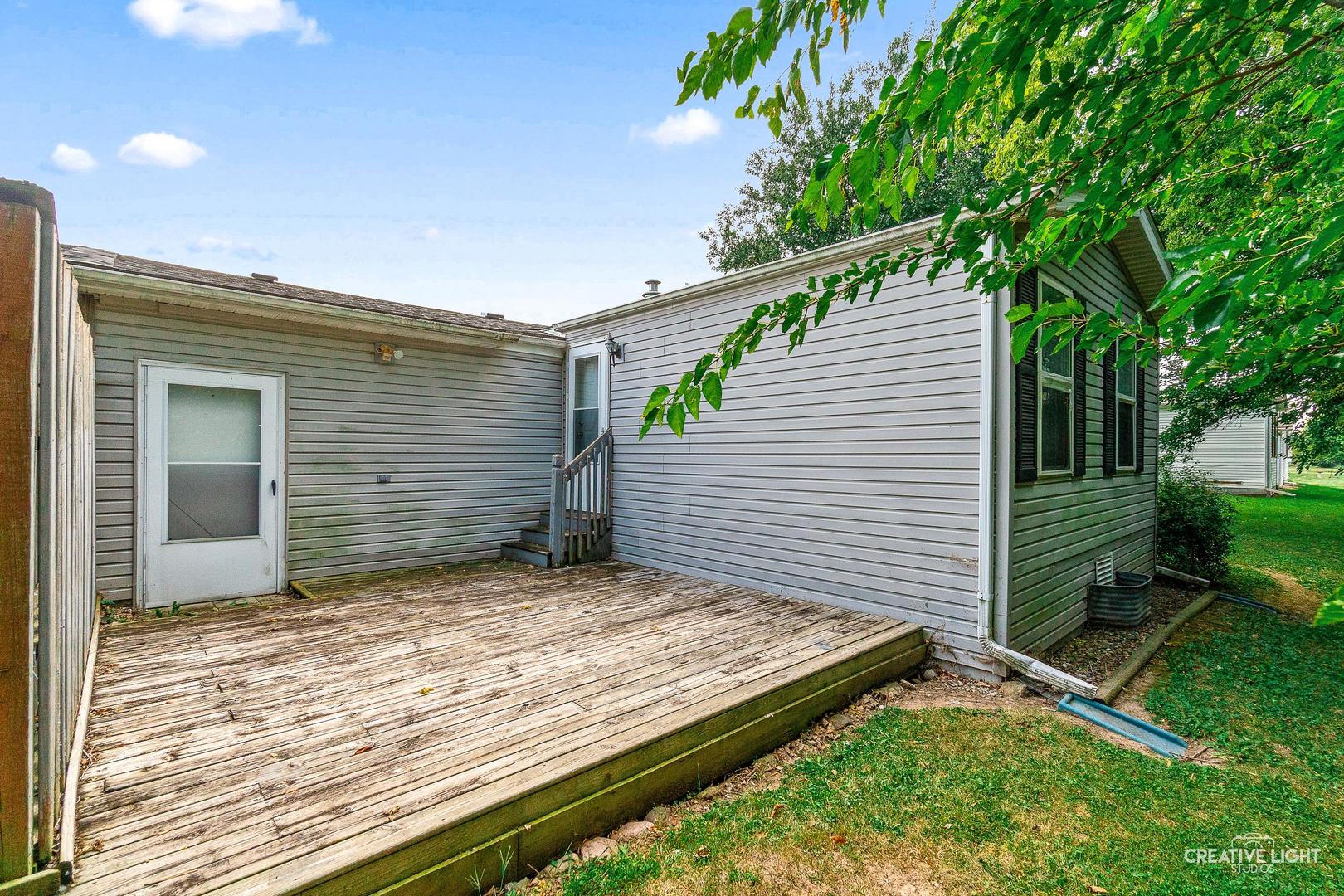 120 Cardinal Lane, Unit A Sandwich, IL 60548 - Photo 14 of 15 a view of a backyard with a large tree
