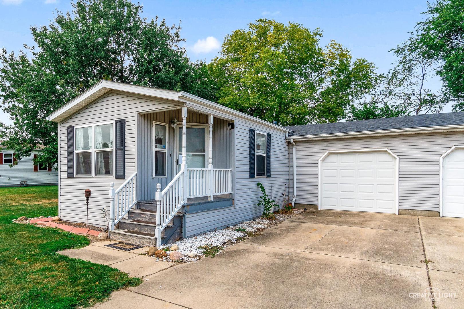 120 Cardinal Lane, Unit A Sandwich, IL 60548 - Photo 2 of 15 a front view of a house with a yard